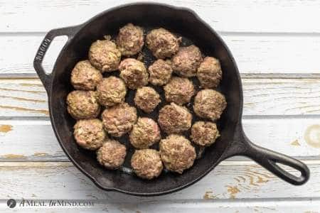 Paleo Pesto Meatballs after searing in iron skillet