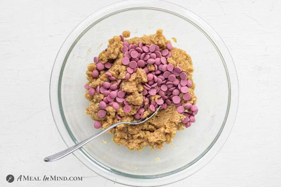 cookie dough with ruby chips in glass mixing bowl