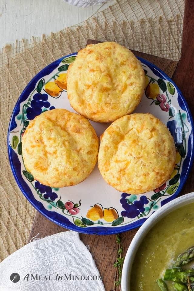 three brazilian cheese rolls on bordered plate