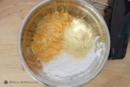 two cheeses and flours in stainless mixing bowl
