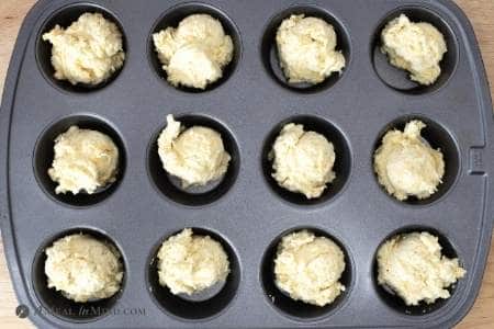 scoops of brazilian cheese bread dough in muffin tin
