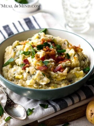 irish colcannon in white bowl with bacon