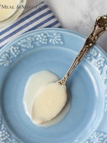 coconut butter in spoon on wood plate