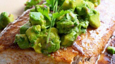 fish baked on parchment then covered with avocado salsa and cilantro